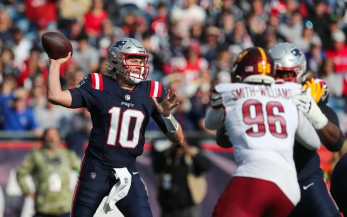 New England Patriots quarterback Mac Jones (10) passes the ball during the first half against the Washington Commanders at Gillette Stadium.
